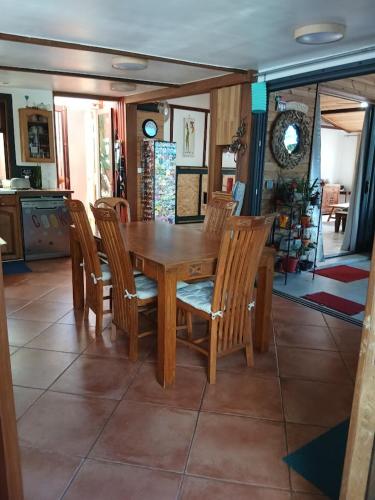 a wooden table and chairs in a kitchen at maison entière in Saint-Pierre
