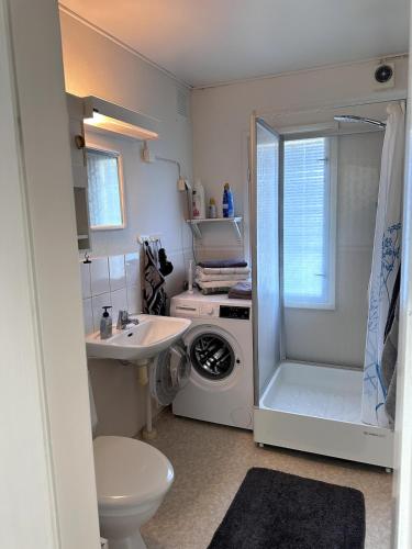 a bathroom with a sink and a washing machine at Peaceful Comfort in Suni
