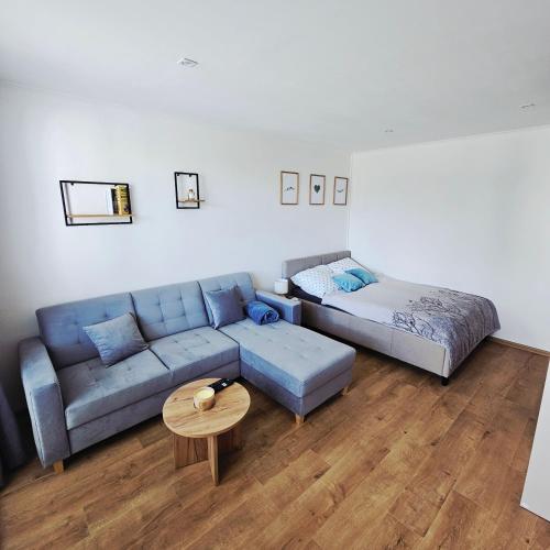 a living room with a couch and a bed at Apartmán Grand in Partizánske