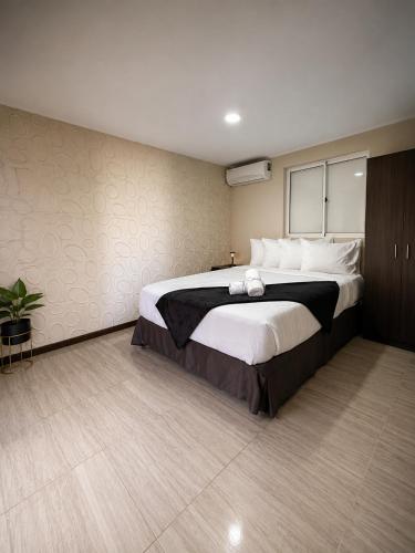 a bedroom with a large bed with white pillows at Valfe Apartments in Palm-Eagle Beach