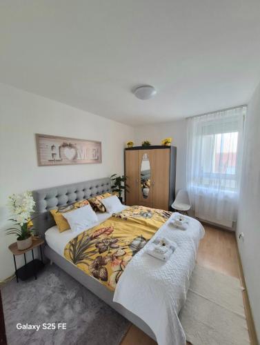 a bedroom with a large bed with two pillows at Zafir Luxory in Kaposvár