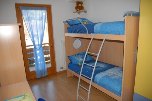 two bunk beds in a room with a ladder at Love & Live Pinè in Baselga di Pinè