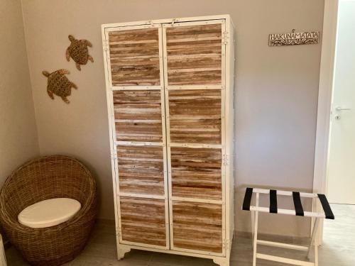 a wooden closet in a room with a toilet at Relax e tranquillità a Cala Pisana in Lampedusa