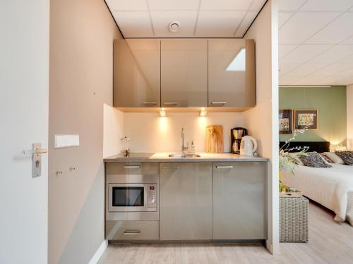 a kitchen with a sink and a bed in a room at Alluring Apartment in Bergen with Terrace, Garden and BBQ in Bergen
