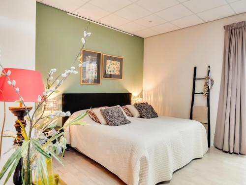 a bedroom with a white bed and a green wall at Alluring Apartment in Bergen with Terrace, Garden and BBQ in Bergen
