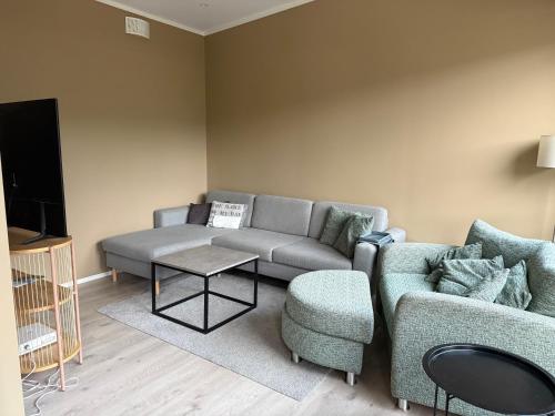 a living room with a couch and a table at Aurora Apartments - Mountain View in Stryn
