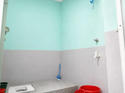 a bathroom with a toilet and a mirror at santosh lodge in Muzaffarpur
