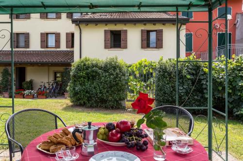 a table with a plate of fruits and vegetables on it at Agriturismo Al Tralcio in Valeggio sul Mincio