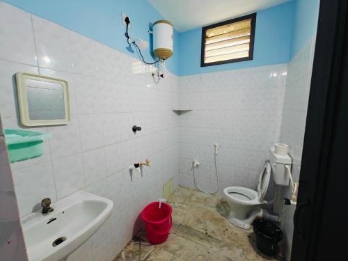 a bathroom with a toilet and a sink at Royal Villa Pondy in Pondicherry