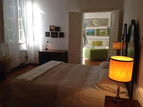 a bedroom with a bed with a lamp and a couch at B&B Le Tortore in Melara