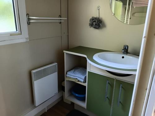 a small bathroom with a sink and a mirror at Bungalow tonga in Moncetz-lʼAbbaye
