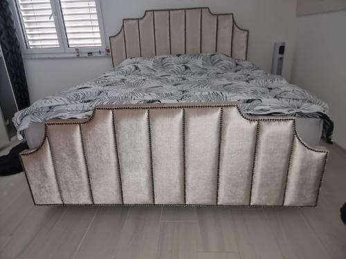a large bed in a room with a wooden floor at Gästezimmer in einen Einfamilienhaus in Rudolfstetten