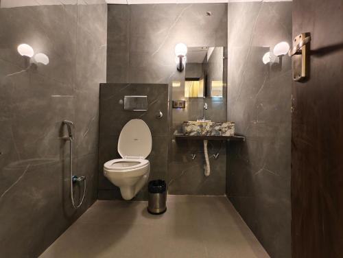 a bathroom with a white toilet and a sink at Hotel hk haridwar By hk guest house in Haridwār
