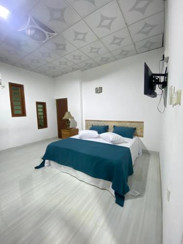 a bedroom with a large bed in a white room at Beloved Regency Homestay in Kandy
