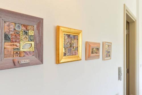 a group of framed pictures on a wall at Apartment Varga in Zadar