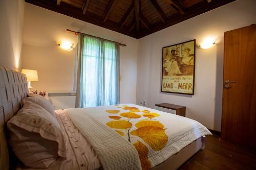 a bedroom with a bed with a flower blanket on it at Eco Stone Villa with Private Pool and Jacuzzi in Kalandra