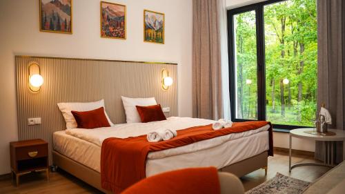 a hotel room with a bed with towels on it at Park Hotel Żywiec in Żywiec