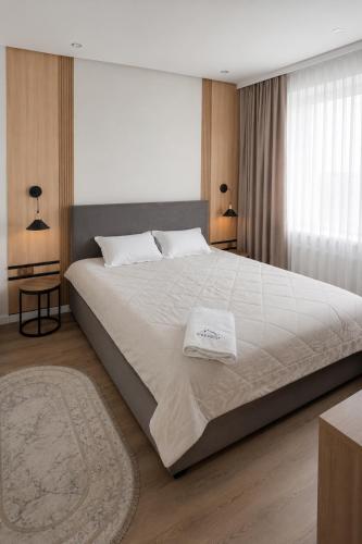 a bedroom with a large bed with two pillows on it at Everest in Zyryanovsk