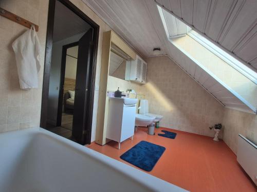 a bathroom with a bath tub and a sink at Stenberg Nature Residence in Tyringe