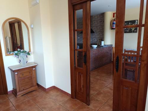 a room with a door and a vase on a table at Los Cerezos in Rada