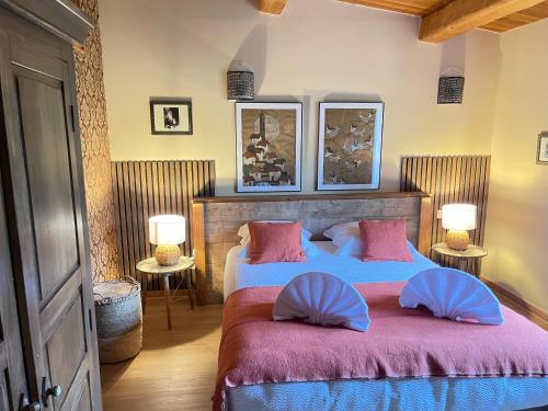 a bedroom with two beds with pink and blue pillows at Chambres d'Hôtes Barraconu in Porto-Vecchio