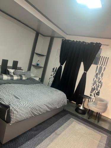 a bedroom with a bed and a table and a chair at Heart of Pasig in Manila