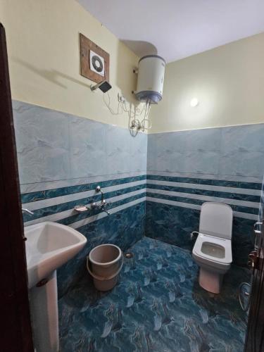 a bathroom with a sink and a toilet at Sai Homestay in Mussoorie