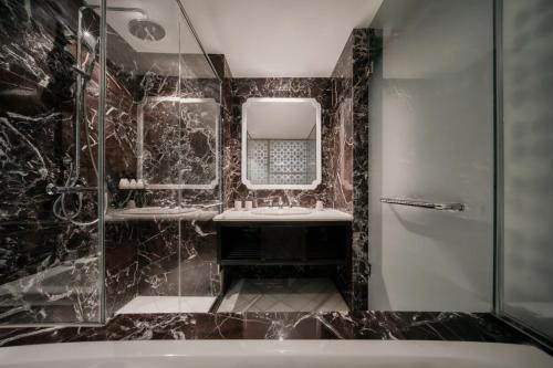 a bathroom with a sink and a mirror at M Village Hotel Long Biên, a brand of Modern Village Lifestyle in Hanoi