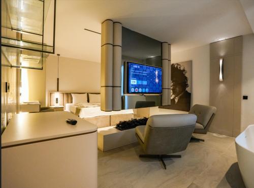 a living room with a bed and a television at VENTO MARE Çeşme in Çeşme
