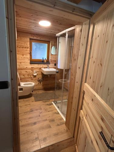 a wooden bathroom with a tub and a sink at HeinrichH in Teuchl