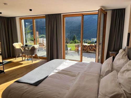 a bedroom with a large bed and a table and chairs at Alpencabin Montafon in Vandans