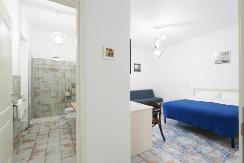 a bedroom with a bed and a bathroom at B&B Centro Storico in Diamante