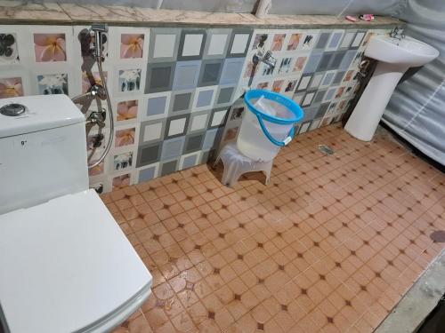 a bathroom with a toilet and a sink at grand holiday camp in Sari
