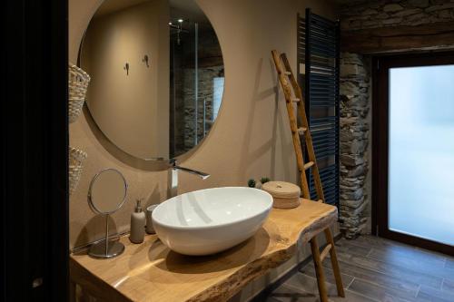 a bathroom with a sink and a mirror on a counter at Little Chariot in Monastero di Lanzo