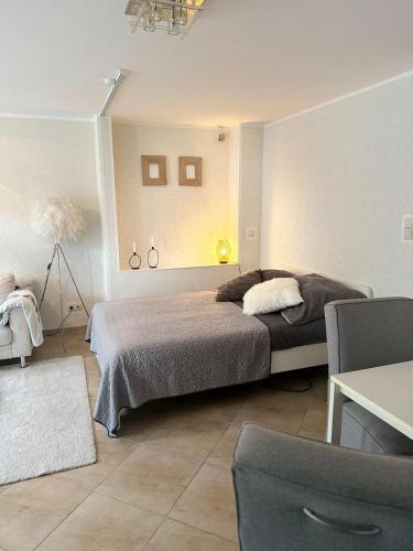 a bedroom with a bed in a room with a table at Monteurwohnung,Ferienwohnung in Lüdenscheid