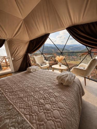 a bedroom with a bed and a large window at GSpace in Yaremche