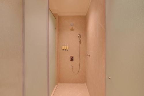 a shower stall in a bathroom with a shower at Lemon Tree Hotel, Sri Ganganagar in Gangānagar