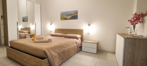 a bedroom with a bed with a teddy bear on it at Il Vicoletto in Pisticci