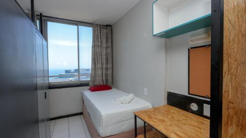 a small room with a bed and a window at Seaboard Apart Hotel in Durban