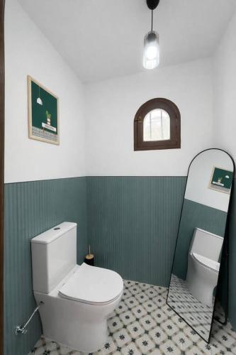 a bathroom with a white toilet and a sink at uBa Vineyard Stay con vistas al Miño Ribeira Sacra in Chantada