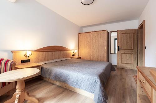 a bedroom with a bed and a wooden floor at Vitosha Park Apart in Sofia