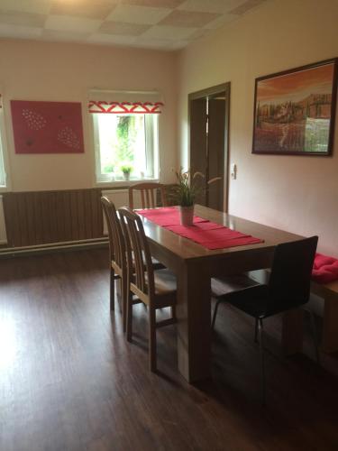 a dining room with a wooden table and chairs at Ferienhaus Strasswirt in Jenig