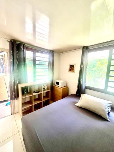 a bedroom with a large bed and a window at Ritualodge in Bora Bora