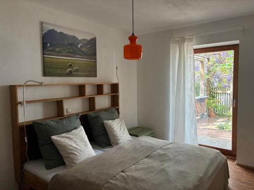 a bedroom with a large bed and a window at Bungaloase in Kelheim