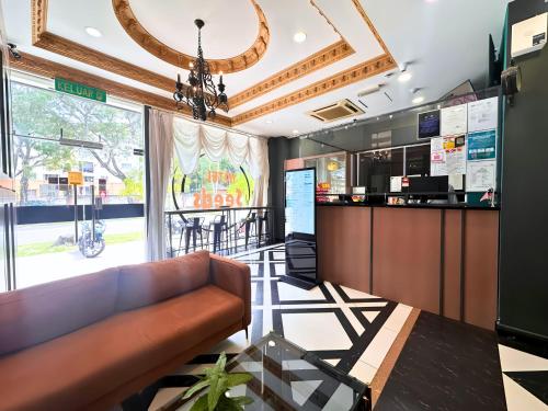 a bar with a couch in a restaurant at Seeds Hotel Shah Alam Section 19 in Shah Alam