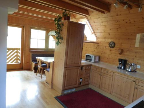 a kitchen in a log cabin with a table at Steinerhof in Sankt Georgen ob Murau