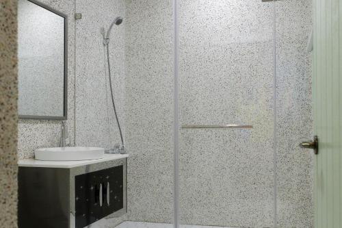 a bathroom with a shower and a sink at My Way House 好巷一弄民宿 in Tainan