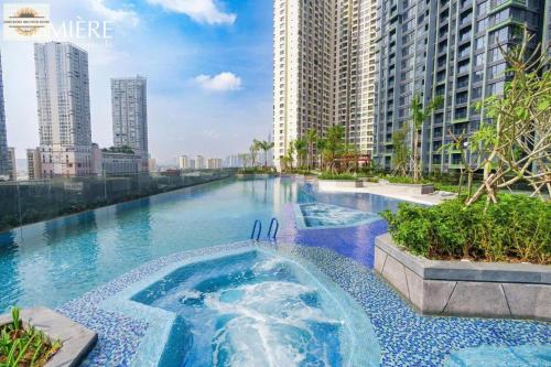 a swimming pool in the middle of a city with tall buildings at Lumiere Riverside Grand Prestige Residence in Ho Chi Minh City