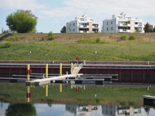 a reflection of two buildings in a body of water at Ferienwohnung Strandblick in Großräschen