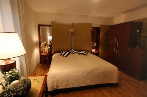 a bedroom with a bed and a table with a lamp at Goldener Adler in Sulzheim